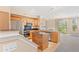 Open kitchen with wooden cabinets, stainless steel appliances, and an island for food preparation at 2154 Concord Ln, Superior, CO 80027