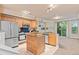Updated kitchen featuring stainless steel appliances, center island, and adjacent living area with fireplace at 2154 Concord Ln, Superior, CO 80027