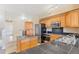 Well-lit kitchen with wood cabinets, stainless steel appliances, and black countertops at 2154 Concord Ln, Superior, CO 80027
