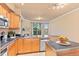 Kitchen featuring stainless steel appliances, black countertops, wood cabinets, and adjacent balcony access at 2154 Concord Ln, Superior, CO 80027