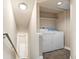 Bright laundry area with washer, dryer, built-in shelving and access to upstairs at 2154 Concord Ln, Superior, CO 80027