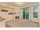 Bright living room with a fireplace, sliding doors to balcony, and large windows at 2154 Concord Ln, Superior, CO 80027