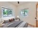Cozy bedroom with large windows offering neighborhood views, plus stylish furnishings and soothing color palette at 2849 S Bannock St, Englewood, CO 80110