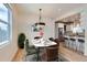 Open concept dining room leading into a modern kitchen with stainless steel appliances at 2849 S Bannock St, Englewood, CO 80110
