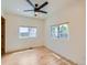 A spacious empty room with lots of natural light, hardwood floors, and a modern ceiling fan at 2849 S Bannock St, Englewood, CO 80110