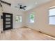 Bright, empty room with hardwood floors, natural light, a modern ceiling fan, and unique access to the roof at 2849 S Bannock St, Englewood, CO 80110