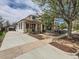 Exterior home showcasing a long driveway, tidy front yard, and freshly painted facade at 2849 S Bannock St, Englewood, CO 80110