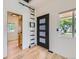 Bright foyer features hardwood floors, modern front door, and decorative ladder at 2849 S Bannock St, Englewood, CO 80110