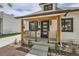 Close-up front porch view showcasing the house number, wood posts, and black trim at 2849 S Bannock St, Englewood, CO 80110