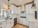 Modern kitchen with white cabinets, quartz countertops, and stainless steel appliances at 2849 S Bannock St, Englewood, CO 80110
