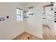 Convenient laundry room with wooden shelving, tile floors, and next to the kitchen at 2849 S Bannock St, Englewood, CO 80110