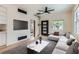 Modern living room features a flat-screen TV, stylish furniture, and an unique decorative access ladder to the roof at 2849 S Bannock St, Englewood, CO 80110