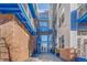 Modern building entrance with brick and glass details, string lights, and potted plants at 1488 Madison St # 310, Denver, CO 80206