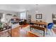 Open concept dining area with wood table and blue chairs at 1488 Madison St # 310, Denver, CO 80206