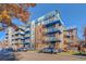 Modern apartment building with blue accents and balconies at 1488 Madison St # 310, Denver, CO 80206