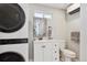 Clean bathroom with a white vanity and a stackable washer/dryer at 2135 N Gilpin St, Denver, CO 80205