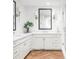 Elegant bathroom with white cabinets, quartz countertops, and herringbone wood floors at 3330 S Columbine Cir, Englewood, CO 80113