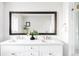 Modern bathroom with double vanity, white cabinets, and large mirror at 3330 S Columbine Cir, Englewood, CO 80113