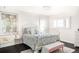 Bright bedroom with a white metal bed frame and window shutters at 3330 S Columbine Cir, Englewood, CO 80113