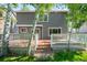 Inviting backyard features a well-maintained wooden deck, steps down to the yard, and mature trees at 3529 Huron Peak Ave, Superior, CO 80027