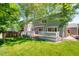 A spacious backyard features a wooden deck and mature trees, offering shade and privacy at 3529 Huron Peak Ave, Superior, CO 80027