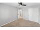 Bedroom with door to bathroom, ceiling fan, and closet with double doors at 3529 Huron Peak Ave, Superior, CO 80027