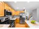 Bright kitchen features stainless appliances, light countertops, herringbone backsplash, and wood cabinetry at 3529 Huron Peak Ave, Superior, CO 80027