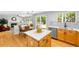 Sunlit kitchen has eat-in dining, a sink, and views into the Gathering room with fireplace and outdoor access at 3529 Huron Peak Ave, Superior, CO 80027