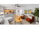 Open-concept living room connects to a kitchen, featuring stylish seating and artwork to enhance the space at 3529 Huron Peak Ave, Superior, CO 80027