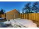 Detached garage with double doors and basketball hoop, located in a fenced backyard at 1190 Elmira St, Aurora, CO 80010