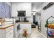 Kitchen with white cabinets, stove and view of living area at 1190 Elmira St, Aurora, CO 80010