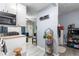 Bright kitchen with white cabinets and view into the living room at 1190 Elmira St, Aurora, CO 80010