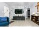 Living room features a stone accent wall, TV, and hardwood-style flooring at 1190 Elmira St, Aurora, CO 80010