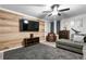 Spacious living room with gray sectional sofa and wood-look walls at 1190 Elmira St, Aurora, CO 80010