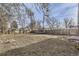 Large backyard with wooden fence, trampoline, and mature trees at 1716 Akron St, Aurora, CO 80010