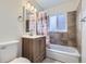 Clean bathroom with a tub, shower, and updated vanity at 1716 Akron St, Aurora, CO 80010