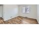 Simple bedroom with hardwood floors and a window at 1716 Akron St, Aurora, CO 80010