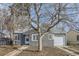 Gray house with white trim, a large tree, and a walkway at 1716 Akron St, Aurora, CO 80010