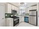 Modern kitchen with stainless steel appliances and green tile backsplash at 1716 Akron St, Aurora, CO 80010