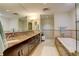 Spacious bathroom with a soaking tub, double sink vanity, and large mirror at 191 Clayton Ln # 402, Denver, CO 80206