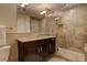 This bathroom features a stylish vanity with dark wood cabinets, a marble countertop, and a glass-enclosed shower at 191 Clayton Ln # 402, Denver, CO 80206