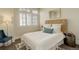 Cozy bedroom features a woven headboard, plush pillows, and soft, neutral tones for a relaxing retreat at 191 Clayton Ln # 402, Denver, CO 80206
