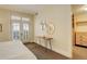 Light-filled bedroom with sleek furniture, a decorative mirror, and access to the outdoors at 191 Clayton Ln # 402, Denver, CO 80206