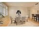 Bright dining area with a glass table, neutral chairs, and modern light fixture at 191 Clayton Ln # 402, Denver, CO 80206