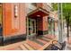 Condo entrance with brick facade, sleek lighting, and distinctive address signage at 191 Clayton Ln # 402, Denver, CO 80206