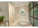 Elegant condo entryway featuring tile floors, a large sliding door closet, and modern artwork at 191 Clayton Ln # 402, Denver, CO 80206