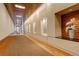 Modern condo hallway featuring recessed lighting, wood accents, and decorative art display at 191 Clayton Ln # 402, Denver, CO 80206