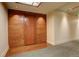 Condo hallway with wood accent wall and carpeting leading to unit 412 at 191 Clayton Ln # 402, Denver, CO 80206
