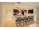 Well-lit kitchen with stainless steel appliances, granite counters and seating for four at 191 Clayton Ln # 402, Denver, CO 80206