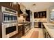 Gourmet kitchen featuring stainless steel appliances, custom cabinets, and stone countertops at 191 Clayton Ln # 402, Denver, CO 80206